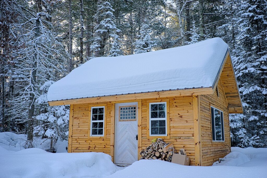 a tiny house surrounded by snow