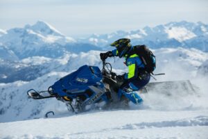 a man riding a snowmobile 2